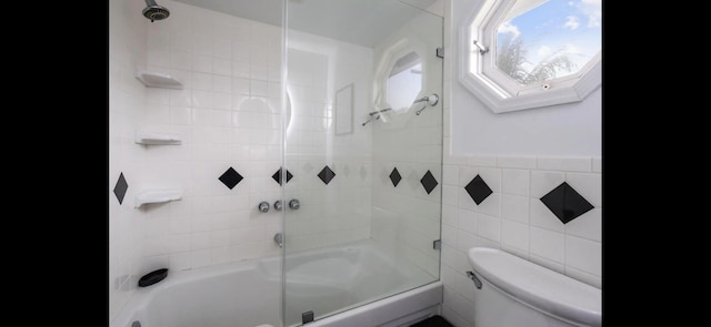 6785 Escondida Dr, Lake Clarke Shores, FL 33406 - full bath with a skylight, toilet, tile walls, and enclosed tub / shower combo