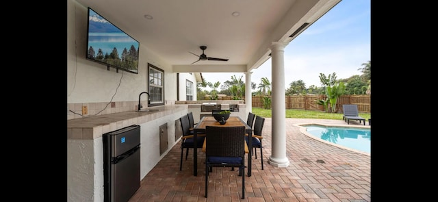 6785 Escondida Dr, Lake Clarke Shores, FL 33406 - view of patio / terrace with a ceiling fan, a sink, area for grilling, a fenced backyard, and a fenced in pool