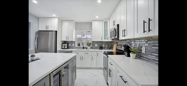 6785 Escondida Dr, Lake Clarke Shores, FL 33406 - kitchen with a sink, marble finish floor, recessed lighting, decorative backsplash, and appliances with stainless steel finishes