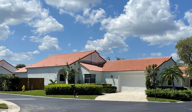 mediterranean / spanish-style home featuring a garage