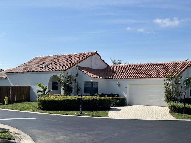 mediterranean / spanish-style house featuring a garage