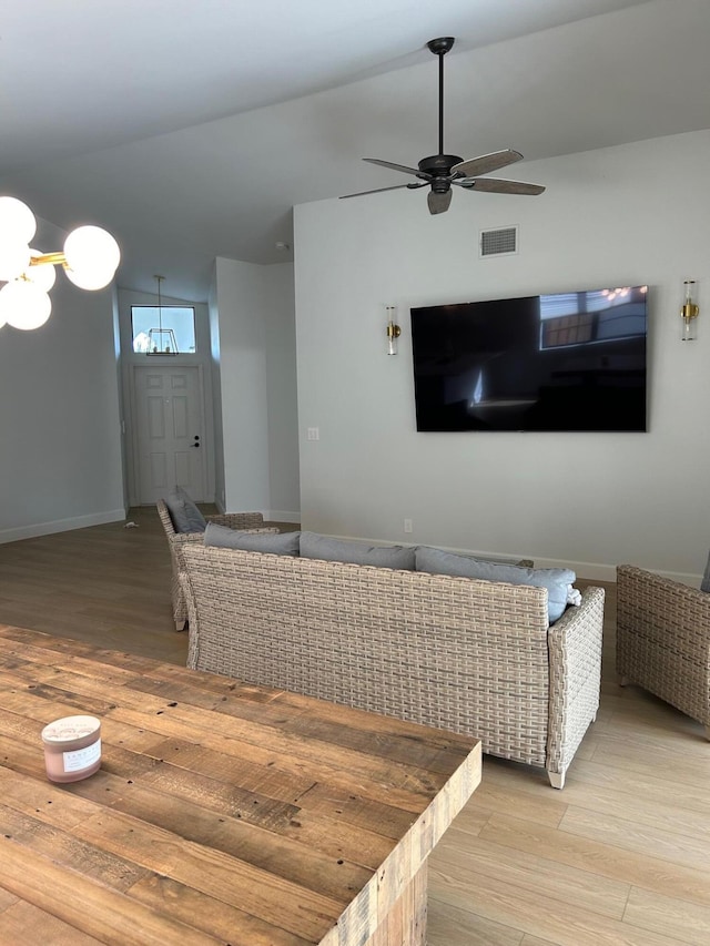 living room featuring ceiling fan and light wood-type flooring