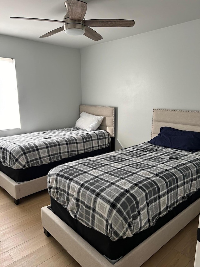 bedroom with ceiling fan and light hardwood / wood-style flooring