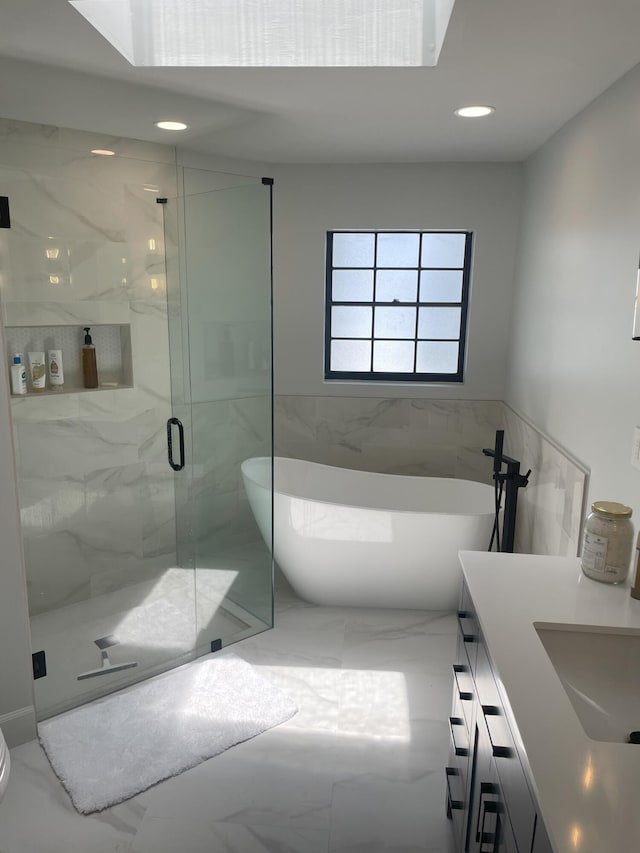 bathroom featuring vanity and shower with separate bathtub