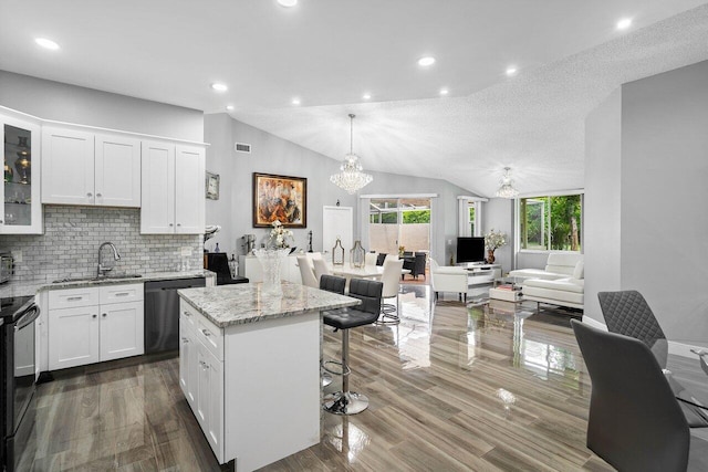 9859 Boca Gardens Cir Unit B, Boca Raton, FL 33496 - kitchen with light stone countertops, white cabinets, dishwasher, a kitchen bar, and a sink
