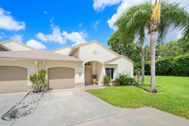 9859 Boca Gardens Cir Unit B, Boca Raton, FL 33496 - view of front of property with a garage, stucco siding, a front yard, and driveway