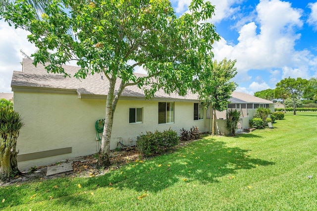 rear view of property featuring a lawn