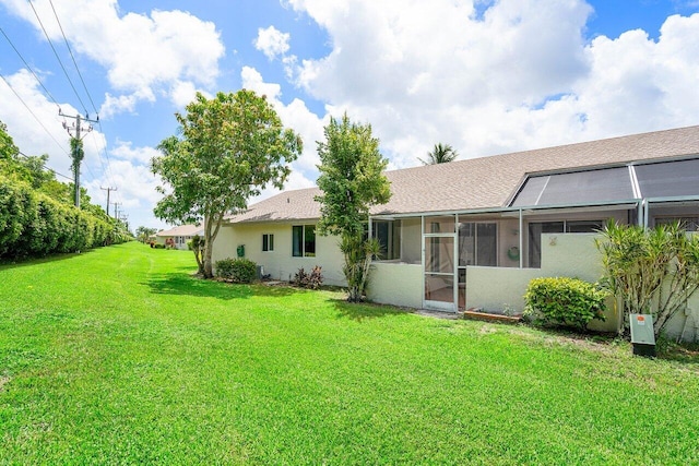 9859 Boca Gardens Cir Unit B, Boca Raton, FL 33496 - back of property with a lawn, stucco siding, and a sunroom