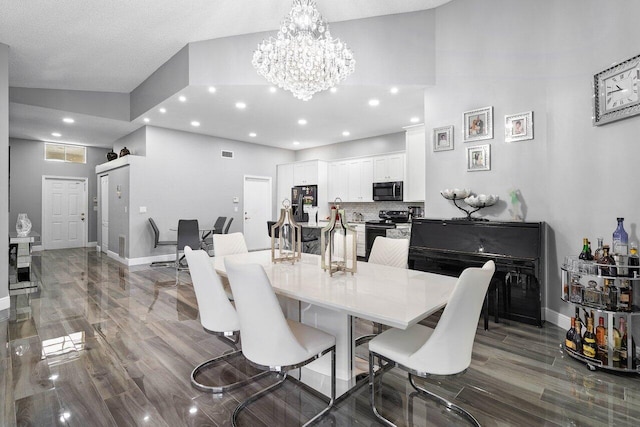 dining space with a textured ceiling, a notable chandelier, and hardwood / wood-style flooring