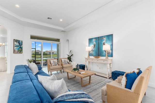 tiled living room with a tray ceiling