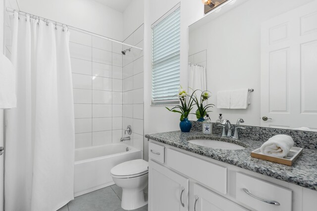 full bathroom with toilet, a healthy amount of sunlight, vanity, and shower / bath combo