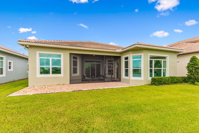 back of house featuring a sunroom and a yard