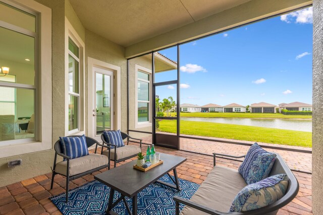 sunroom / solarium with a water view