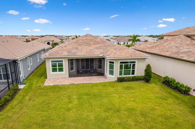 rear view of property with a patio and a yard