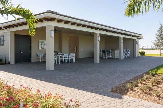 rear view of property featuring a patio area and a garage