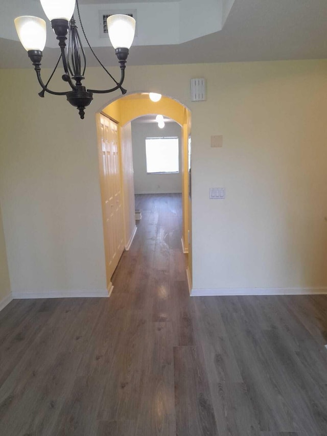 hall featuring a notable chandelier and dark hardwood / wood-style floors