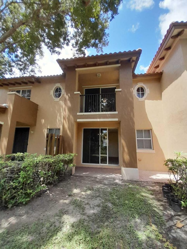 rear view of property with a balcony