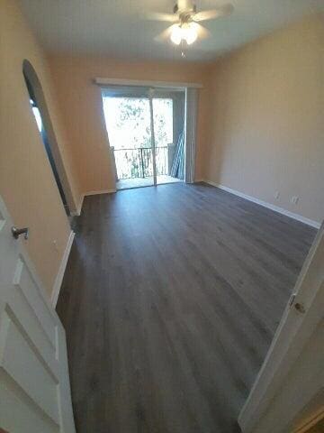 spare room featuring ceiling fan and hardwood / wood-style floors