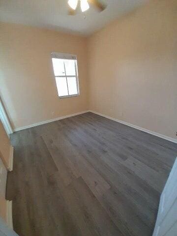 unfurnished room with ceiling fan and hardwood / wood-style flooring