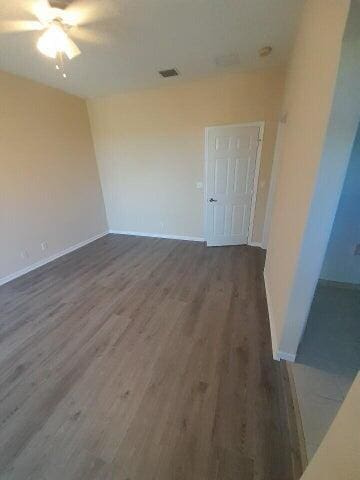 spare room featuring hardwood / wood-style flooring and ceiling fan