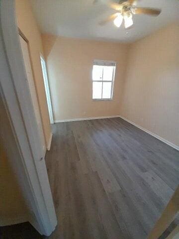 spare room with ceiling fan and hardwood / wood-style flooring