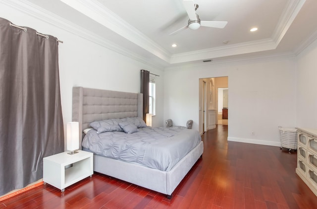 bedroom featuring a tray ceiling, ceiling fan, hardwood / wood-style floors, and ornamental molding