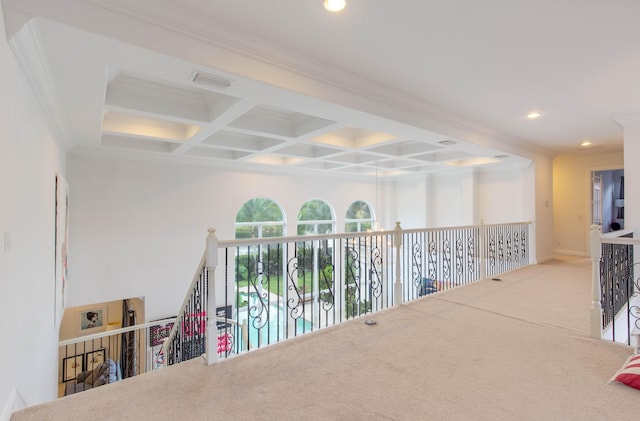 hall with carpet floors, ornamental molding, coffered ceiling, and beamed ceiling