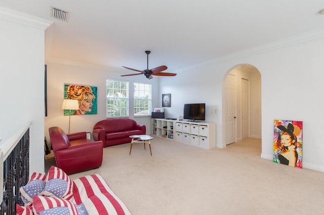 living room featuring light colored carpet, crown molding, and ceiling fan