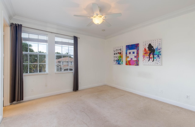 carpeted empty room with ceiling fan and crown molding