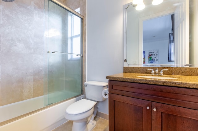 full bath featuring shower / bath combination with glass door, vanity, toilet, and tile patterned floors