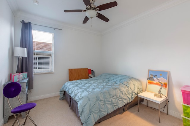 carpeted bedroom with ceiling fan and ornamental molding