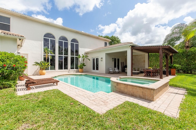 view of swimming pool featuring a lawn, a pergola, an in ground hot tub, and a patio area