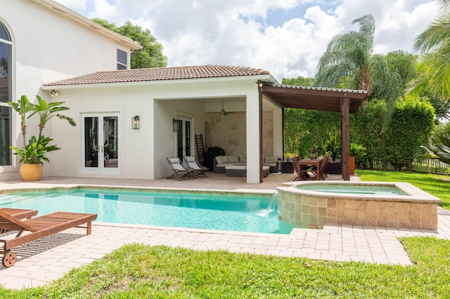 exterior space featuring a patio area, a pool with hot tub, and ceiling fan