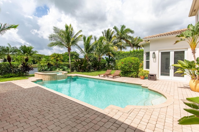 view of swimming pool with a patio, french doors, fence, and a pool with connected hot tub