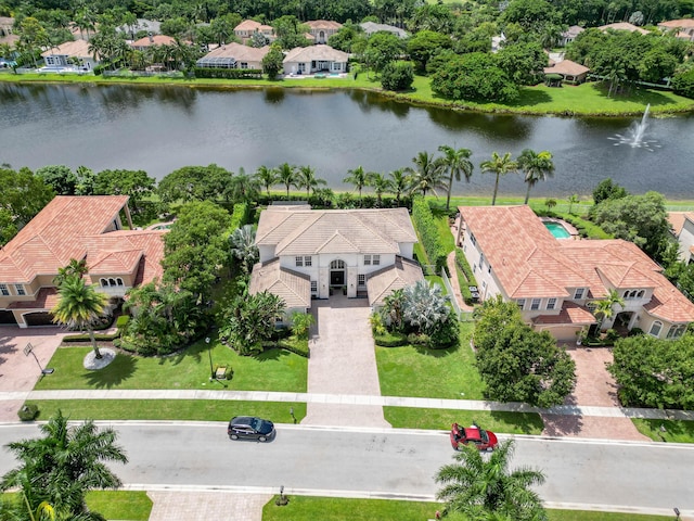 drone / aerial view featuring a residential view and a water view