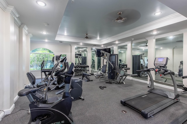 workout area with baseboards, a tray ceiling, recessed lighting, and crown molding