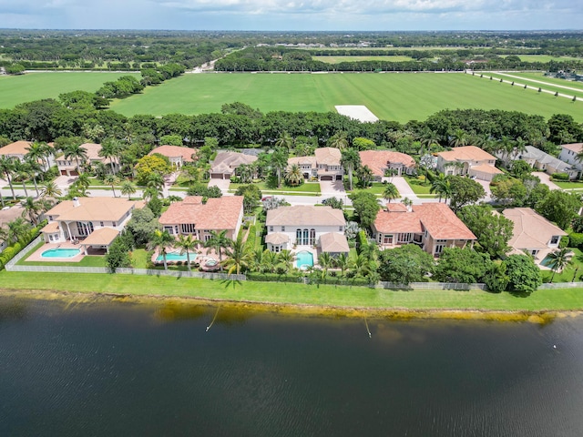 birds eye view of property with a water view and a residential view