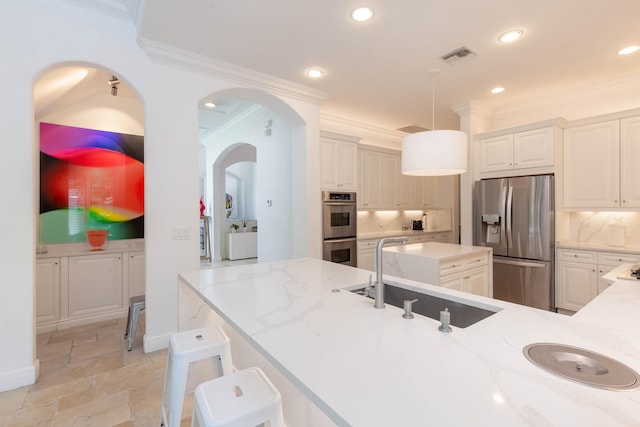 kitchen with backsplash, stainless steel appliances, sink, light tile patterned flooring, and hanging light fixtures