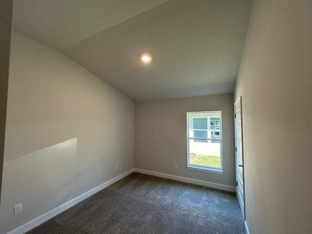 5483 Lugo St, Fort Pierce, FL 34951 - empty room featuring dark colored carpet, baseboards, lofted ceiling, and recessed lighting