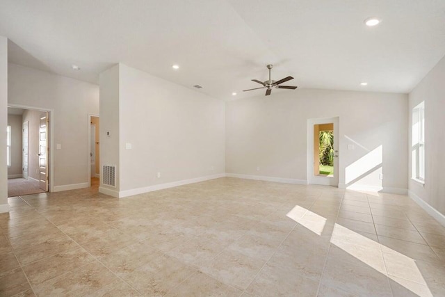 tiled spare room featuring a wealth of natural light, lofted ceiling, and ceiling fan