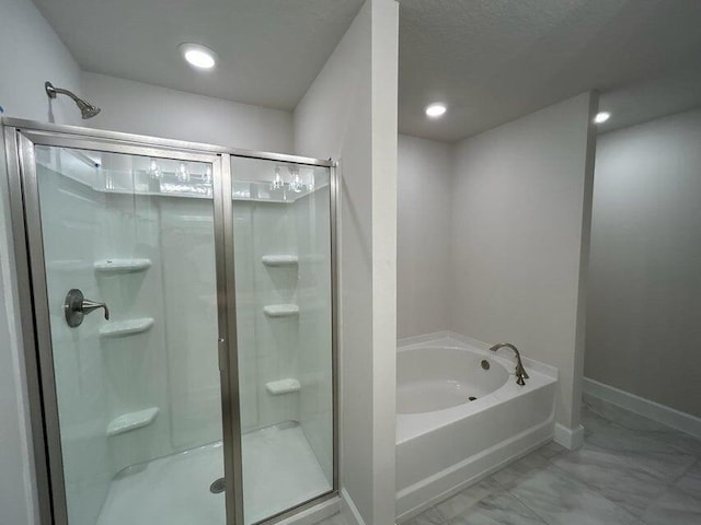 5483 Lugo St, Fort Pierce, FL 34951 - full bathroom featuring a shower stall, marble look tile flooring, a garden tub, baseboards, and recessed lighting