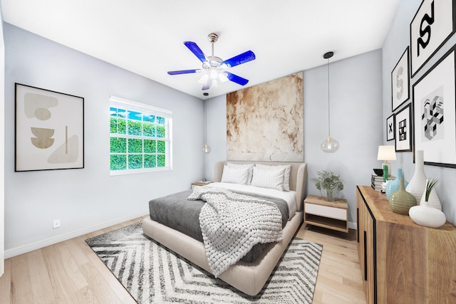 bedroom with ceiling fan and light hardwood / wood-style flooring