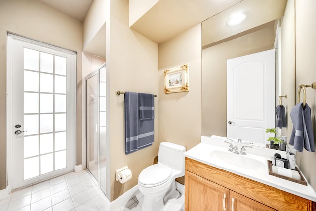 bathroom with tile patterned flooring, vanity, a shower with door, and toilet