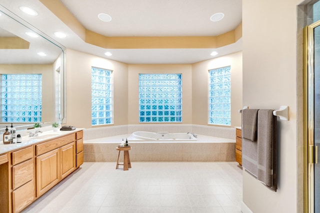 bathroom with vanity, a wealth of natural light, and independent shower and bath