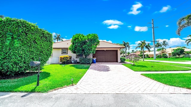 obstructed view of property with a front lawn and a garage