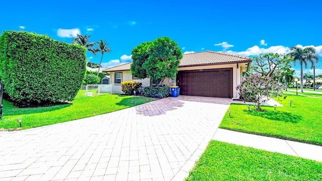 view of front of property featuring a garage and a front lawn