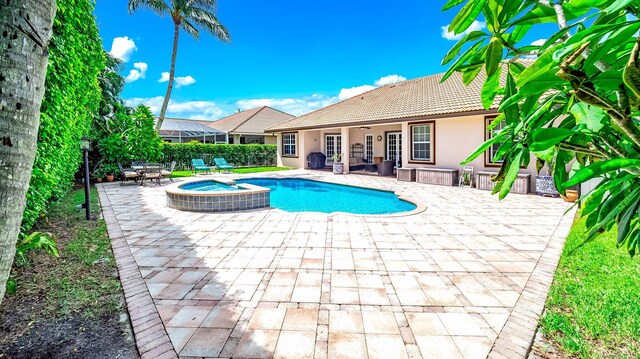 rear view of property featuring a fenced in pool, a yard, a patio, and a storage shed