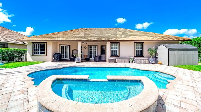 view of pool with an in ground hot tub and a patio area