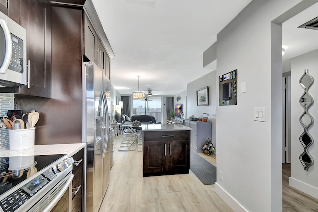 kitchen featuring light hardwood / wood-style floors, dark brown cabinetry, and stainless steel appliances