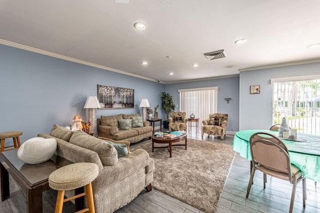 living room with ornamental molding and wood-type flooring